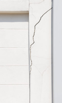 Texture white concrete wall has cracks